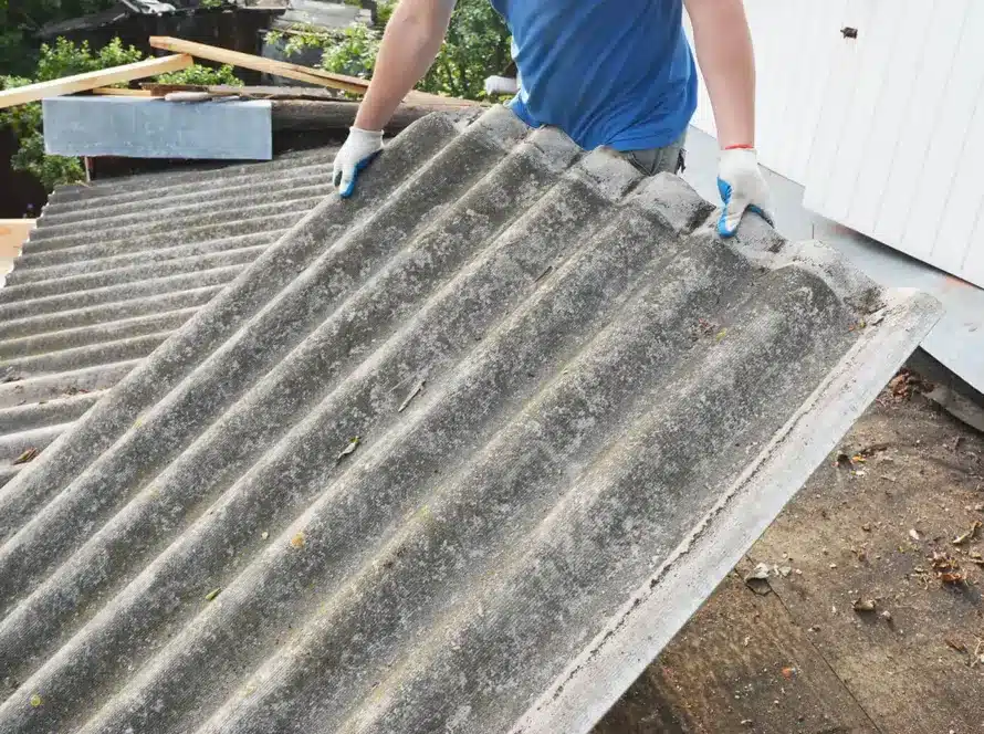 Asbestos roof removal. Asbestos removal and roof renovation. Roofer remove old asbestos cement sheet.